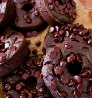 a picture of blender dark chocolate donuts topped with vegan chocolate chips