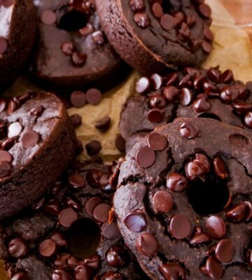 a picture of blender dark chocolate donuts topped with vegan chocolate chips
