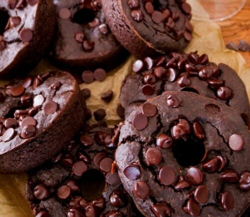 a picture of blender dark chocolate donuts topped with vegan chocolate chips