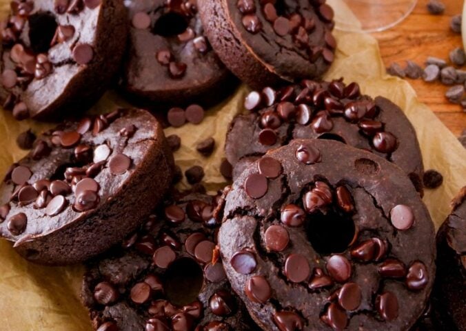 a picture of blender dark chocolate donuts topped with vegan chocolate chips