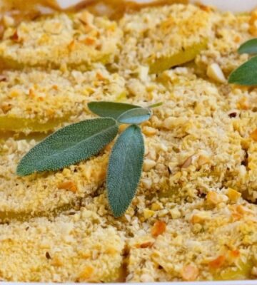 a picture of a mushroom, leek, and borlotti bean pie topped with a herbed potato crust