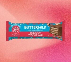 A bar of Buttermilk wafer chocolate bar in front of a light red background