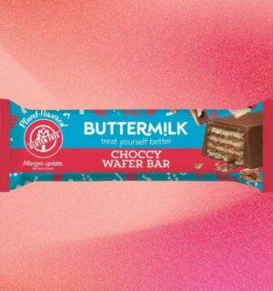 A bar of Buttermilk wafer chocolate bar in front of a light red background