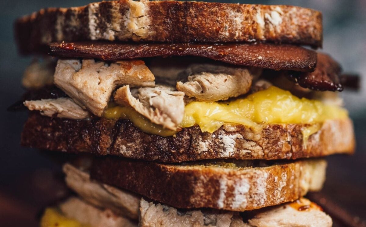 a picture of stacked vegan bacon and chicken toasted sandwiches made with all vegan ingredients