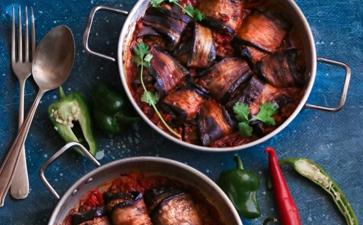 a picture of eggplant roll-ups in a tomato sauce