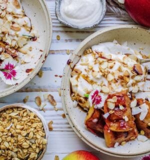 A vegan grilled apple dish served with coconut cream and flaked almonds