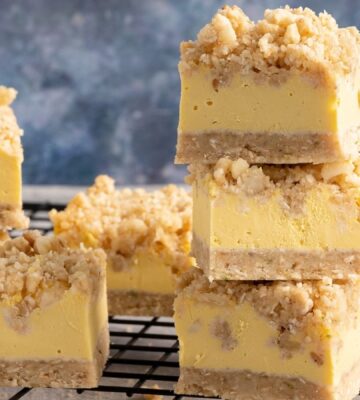 a picture of stacked vegan Hawaiian sunshine crumble squares made with tropical fruit, coconut, and rolled oats
