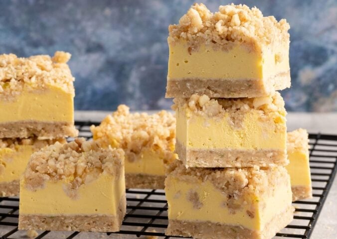 a picture of stacked vegan Hawaiian sunshine crumble squares made with tropical fruit, coconut, and rolled oats