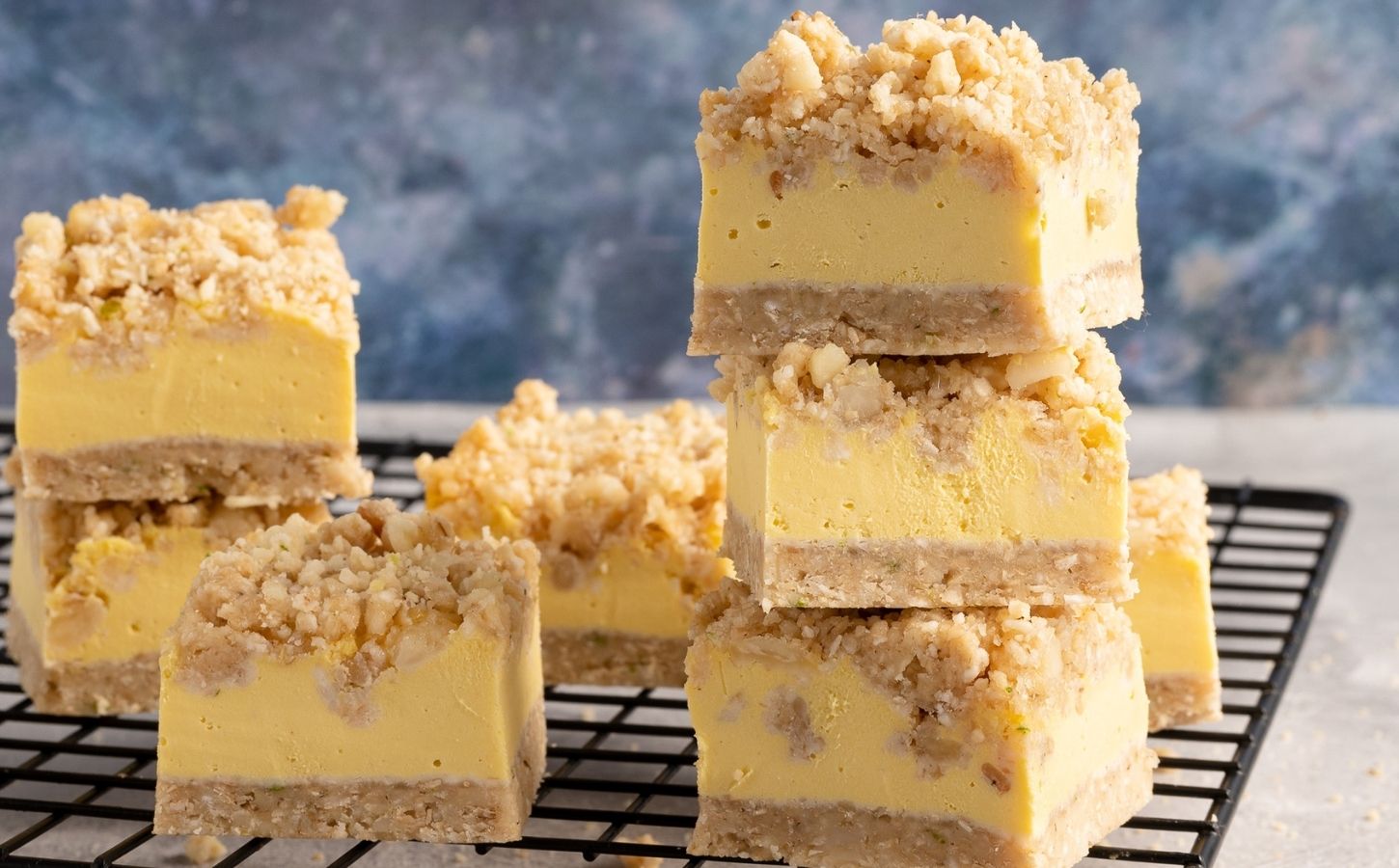 a picture of stacked vegan Hawaiian sunshine crumble squares made with tropical fruit, coconut, and rolled oats