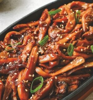 a picture of Korean bulgogi mushrooms made with king oyster mushrooms, and served with rice and vegan kimchi