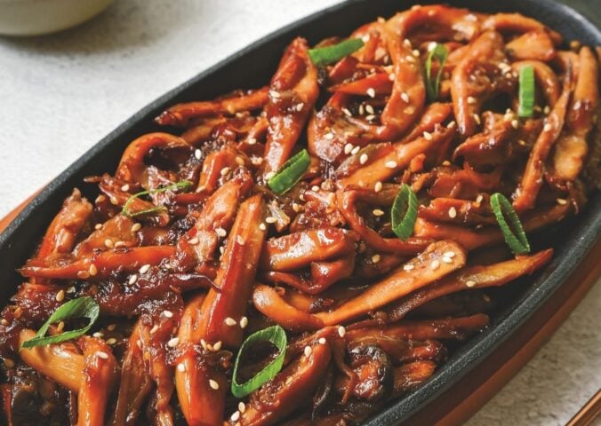 a picture of Korean bulgogi mushrooms made with king oyster mushrooms, and served with rice and vegan kimchi