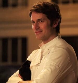 A still of Lucas Bravo's character Gabriel wearing his chef uniform in Netflix show Emily in Paris