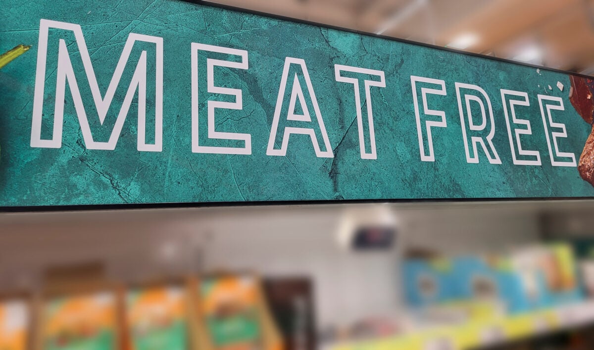 A large sign saying "meat free" in the plant-based meat section of a UK supermarket