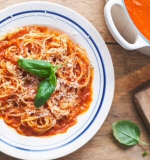 a picture of Nonna's pasta with tomato sauce topped with basil and vegan Parmesan