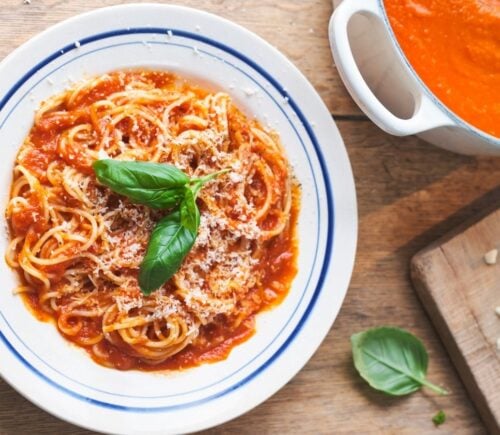 a picture of Nonna's pasta with tomato sauce topped with basil and vegan Parmesan