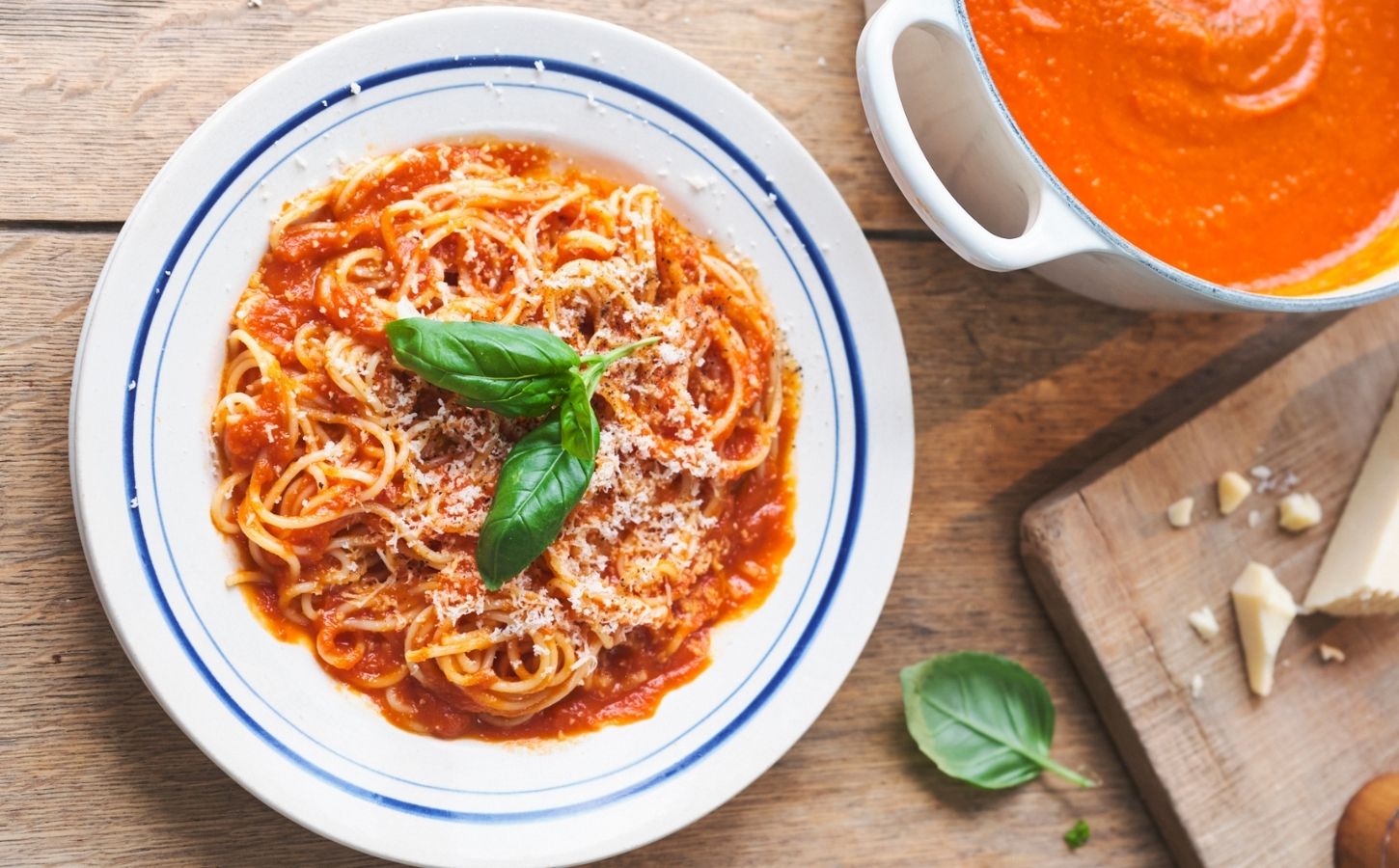 a picture of Nonna's pasta with tomato sauce topped with basil and vegan Parmesan