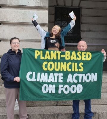 Campaigners from Plant-Based Councils celebrating outside the town hall