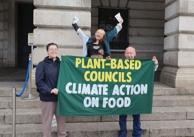 Campaigners from Plant-Based Councils celebrating outside the town hall