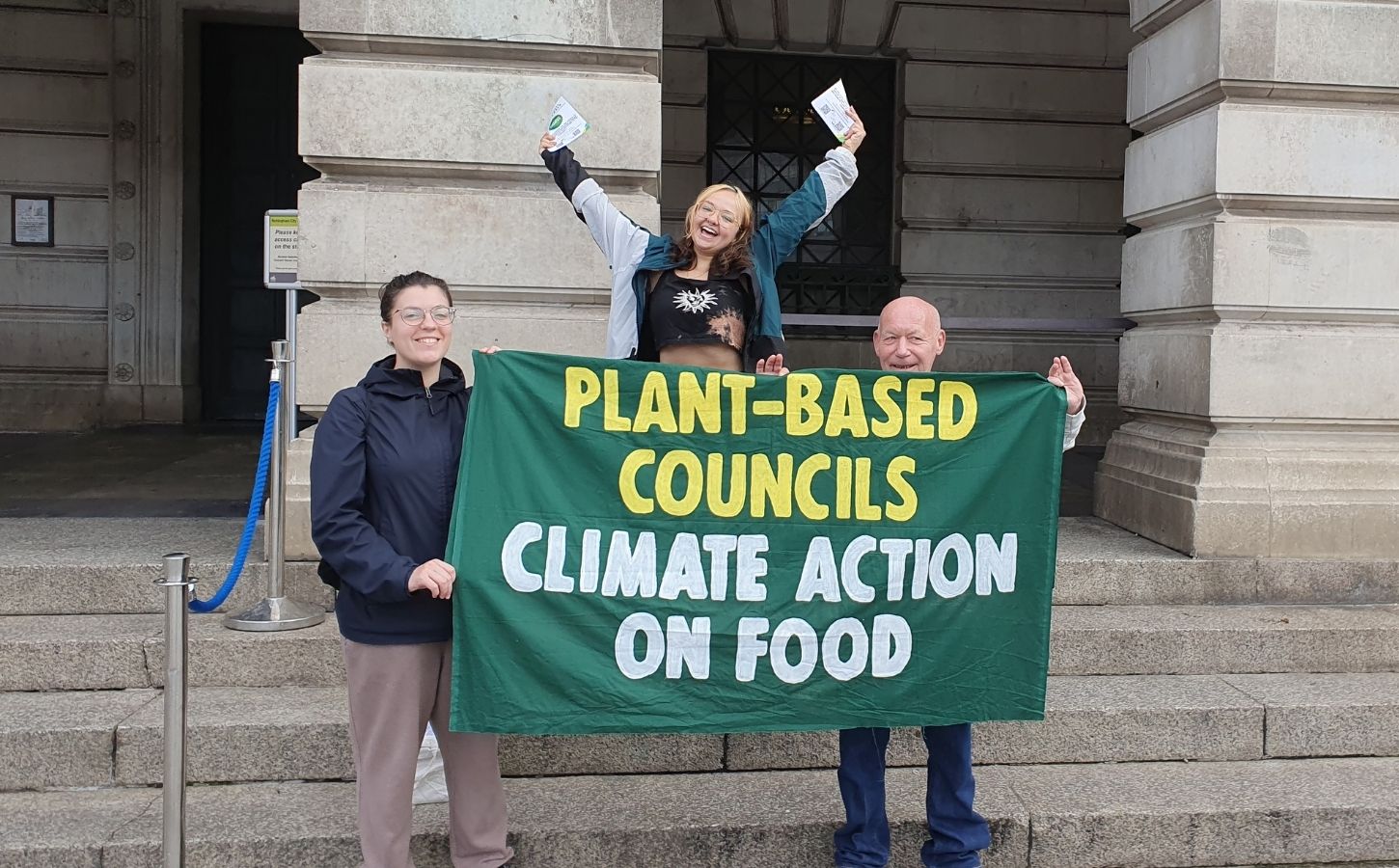 Campaigners from Plant-Based Councils celebrating outside the town hall