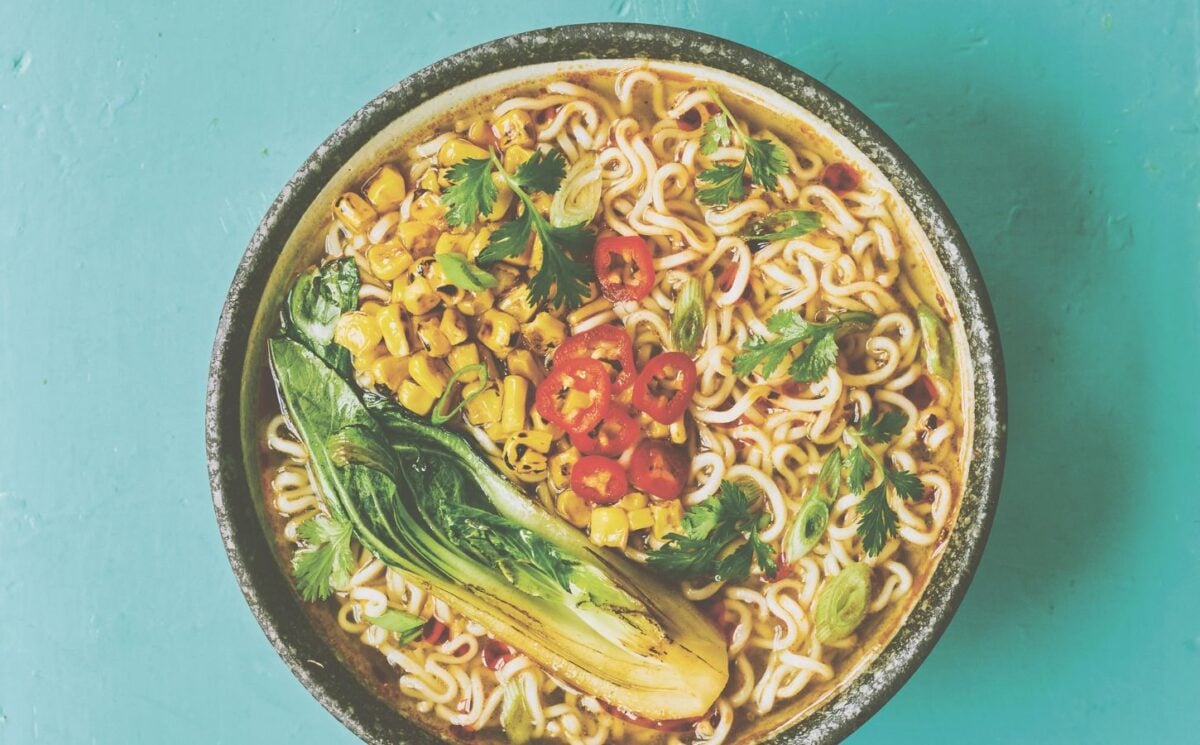 a picture of a pimped instant ramen bowl with sweetcorn, bak choy, and chili