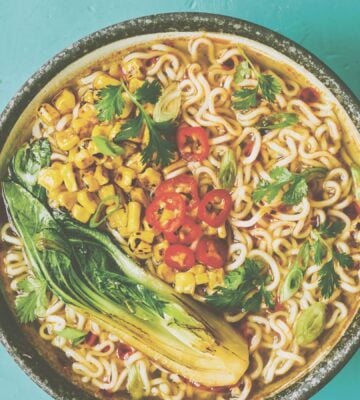 a picture of a pimped instant ramen bowl with sweetcorn, bak choy, and chili