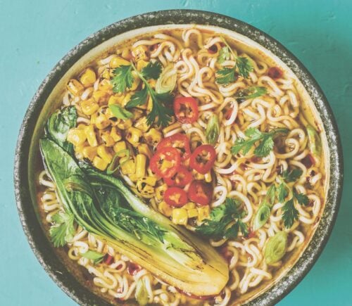 a picture of a pimped instant ramen bowl with sweetcorn, bak choy, and chili