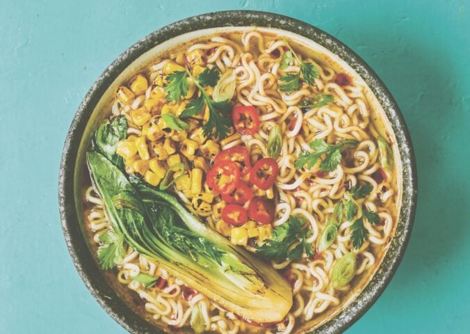 a picture of a pimped instant ramen bowl with sweetcorn, bak choy, and chili