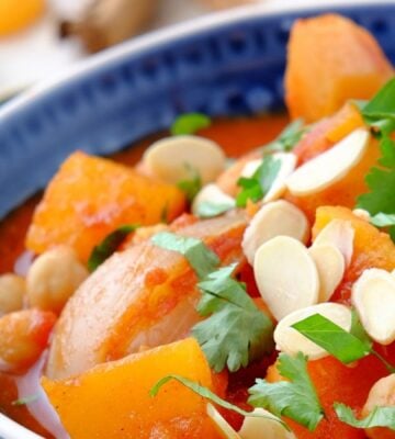 a picture of a seasonal root vegetable tagine topped with almonds and coriander