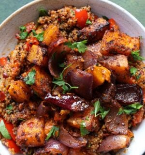 a picture of a speedy squash bowl with butternut, quinoa, tomato, harissa, onion, and red pepper