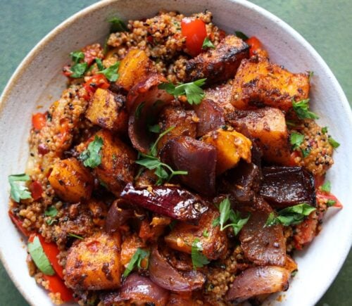 a picture of a speedy squash bowl with butternut, quinoa, tomato, harissa, onion, and red pepper