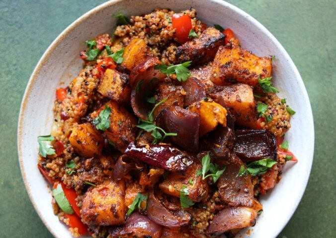 a picture of a speedy squash bowl with butternut, quinoa, tomato, harissa, onion, and red pepper