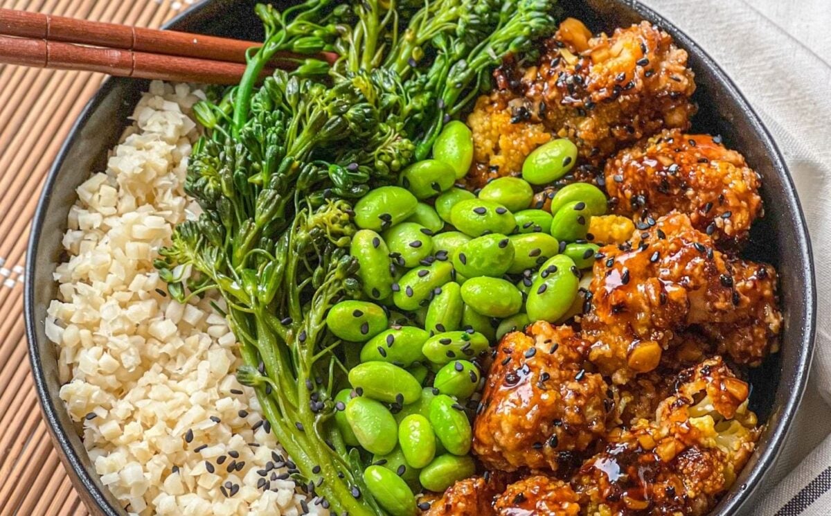 a picture of a tasty-as-takeout teriyaki cauliflower bowl made with heart of palm rice, teriyaki cauliflower, edamame, and broccolini