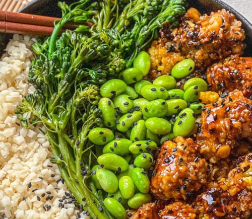 a picture of a tasty-as-takeout teriyaki cauliflower bowl made with heart of palm rice, teriyaki cauliflower, edamame, and broccolini