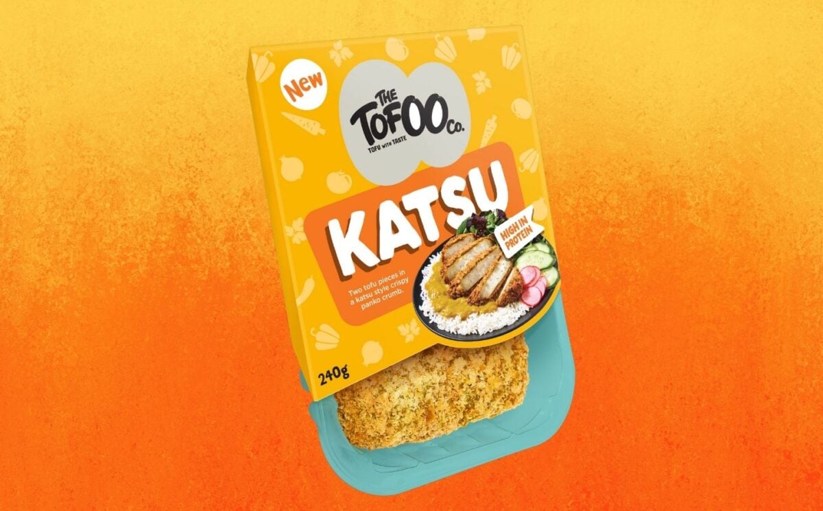 A packet of vegan Tofoo katsu in front of an orange background