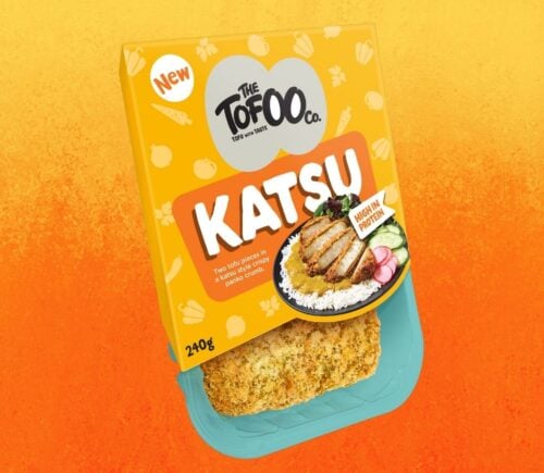 A packet of vegan Tofoo katsu in front of an orange background