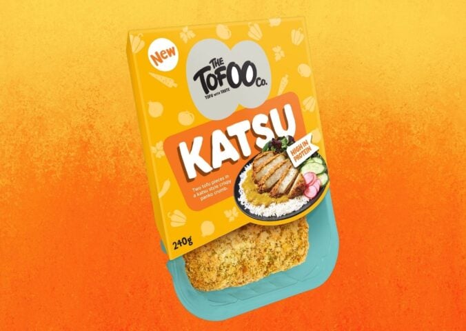 A packet of vegan Tofoo katsu in front of an orange background