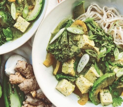 A bowl of high protein vegan avocado noodles complete with tofu, broccoli, and peppers