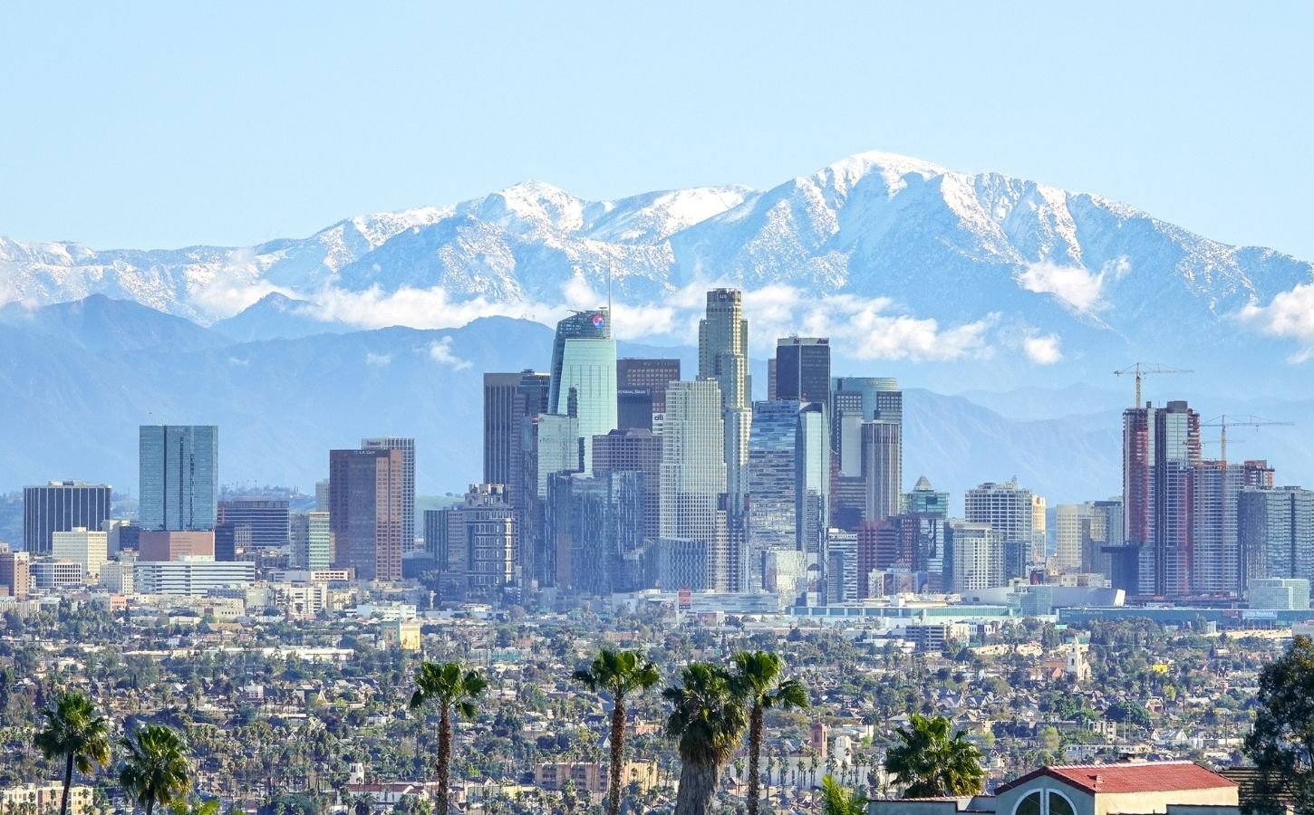 Photo shows the Los Angeles skyline against its backdrop of mountains