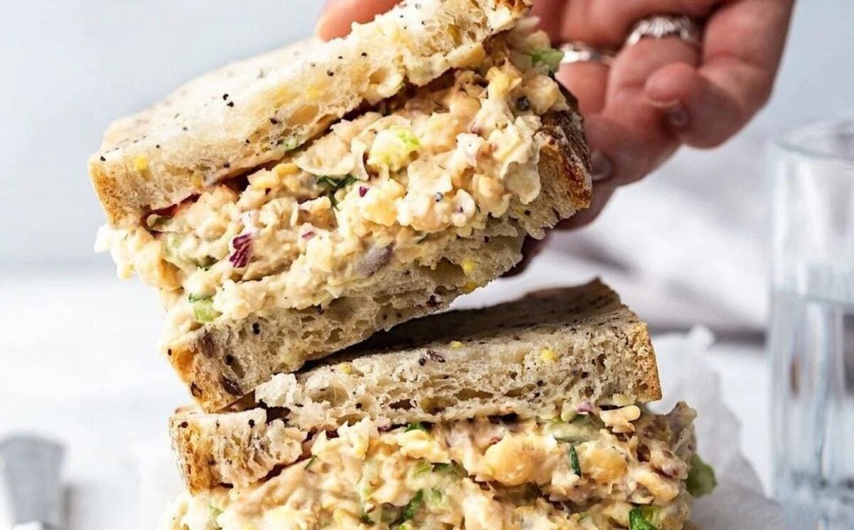 A vegan chickpea tuna mayo being placed on a wooden board