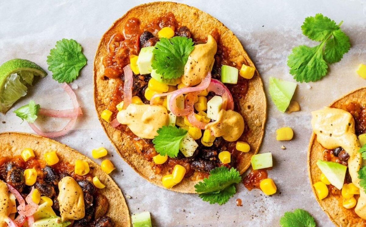 Vegan spicy black bean tostadas with a dairy-free cheese sauce