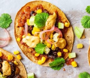 Vegan spicy black bean tostadas with a dairy-free cheese sauce