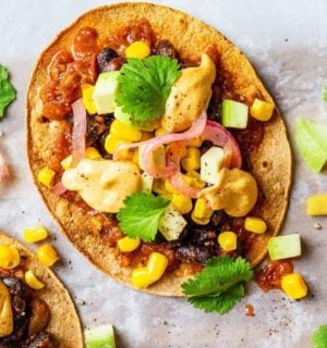 Vegan spicy black bean tostadas with a dairy-free cheese sauce