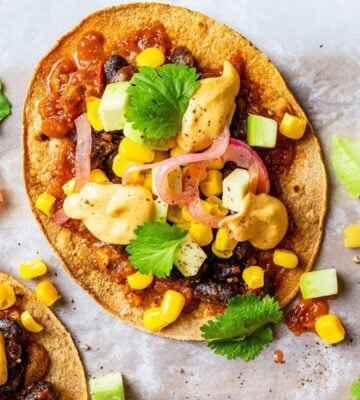 Vegan spicy black bean tostadas with a dairy-free cheese sauce