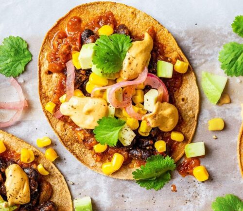 Vegan spicy black bean tostadas with a dairy-free cheese sauce