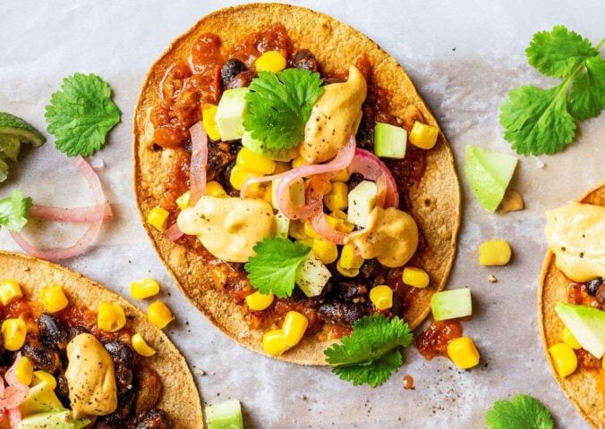 Vegan spicy black bean tostadas with a dairy-free cheese sauce