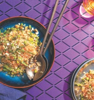 a picture of a plate of Indo-Chinese pulao, a completely vegan fried rice dish with carrots, peas, onion, and cashews