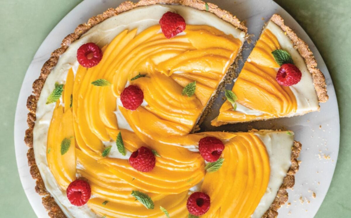 a chai-spiced custard tart with mango with an oat base and raspberry topping