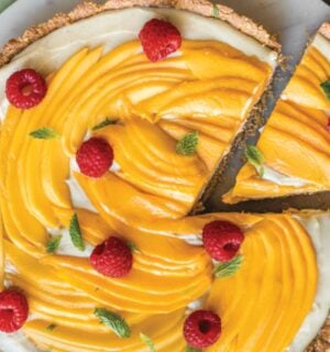 a chai-spiced custard tart with mango with an oat base and raspberry topping