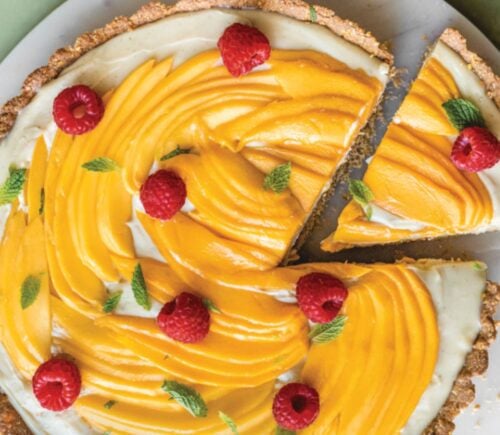 a chai-spiced custard tart with mango with an oat base and raspberry topping