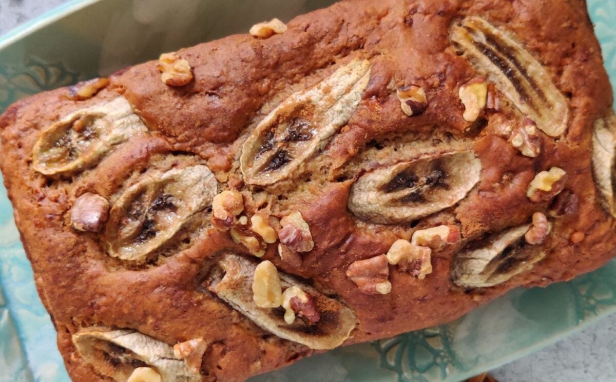 a picture of a chai spiced vegan banana bread loaf topped with sliced bananas